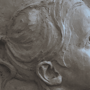 Child's profile sculpted in clay relief.